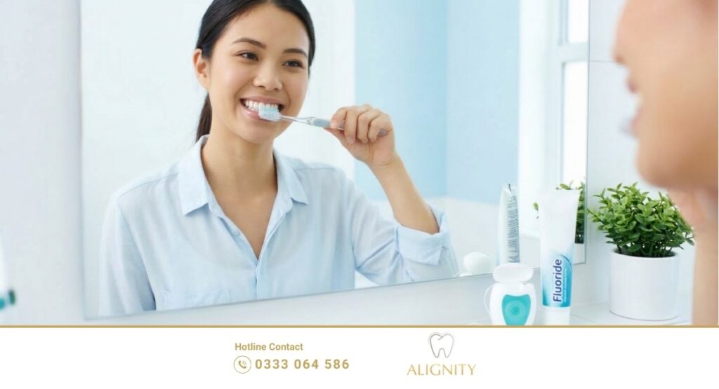 Một người đang thực hiện vệ sinh răng miệng đúng cách tại nhà với bàn chải lông mềm. 